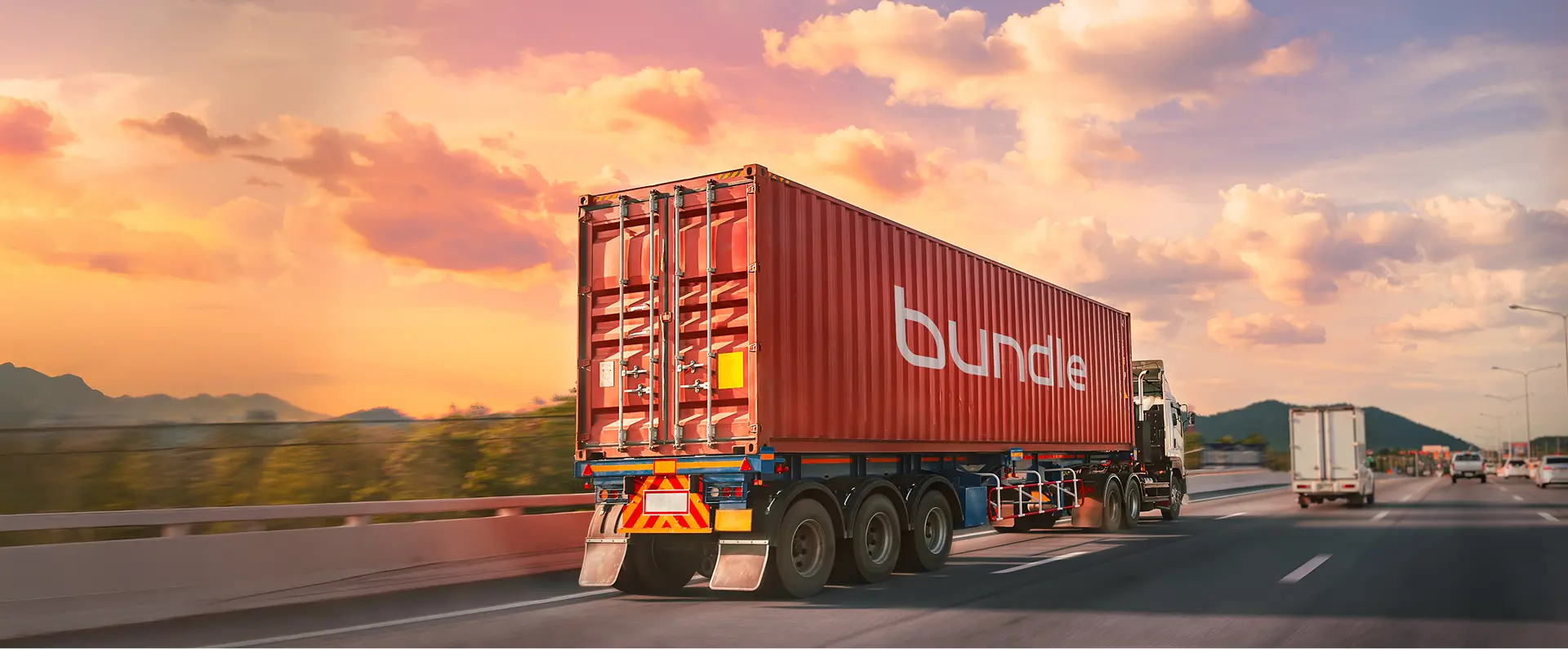 Bundle container carried by truck on the highway at sunset